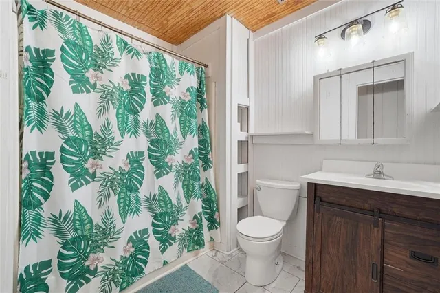 a bathroom with a toilet a sink and a window