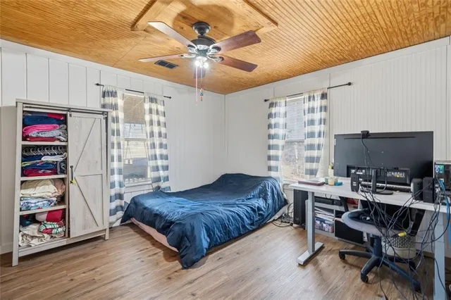 a bedroom with a bed and a book shelf