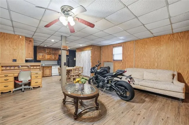 a living room with furniture a wooden floor and next to a window