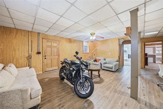 a spacious bedroom with furniture and a wooden floor