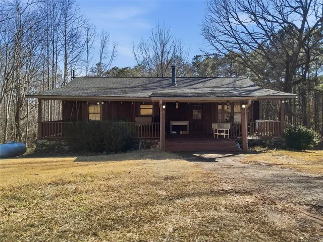 a view of a house with a yard covered with snow