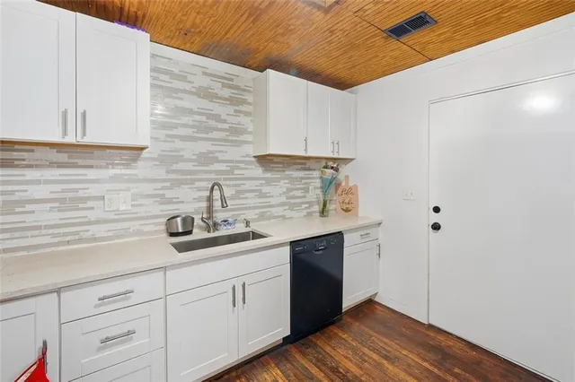 a kitchen with a sink and cabinets