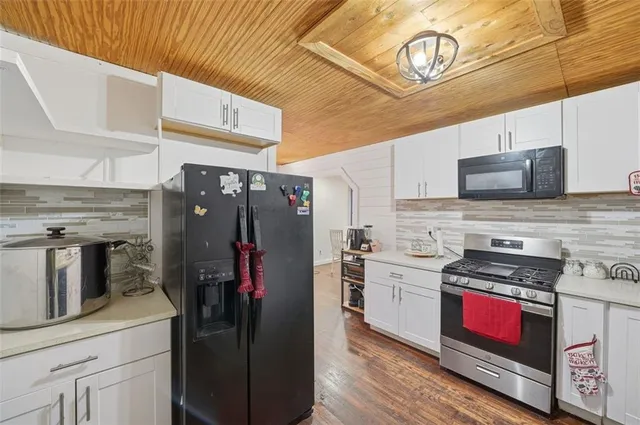 a kitchen with stainless steel appliances a stove a refrigerator and a sink