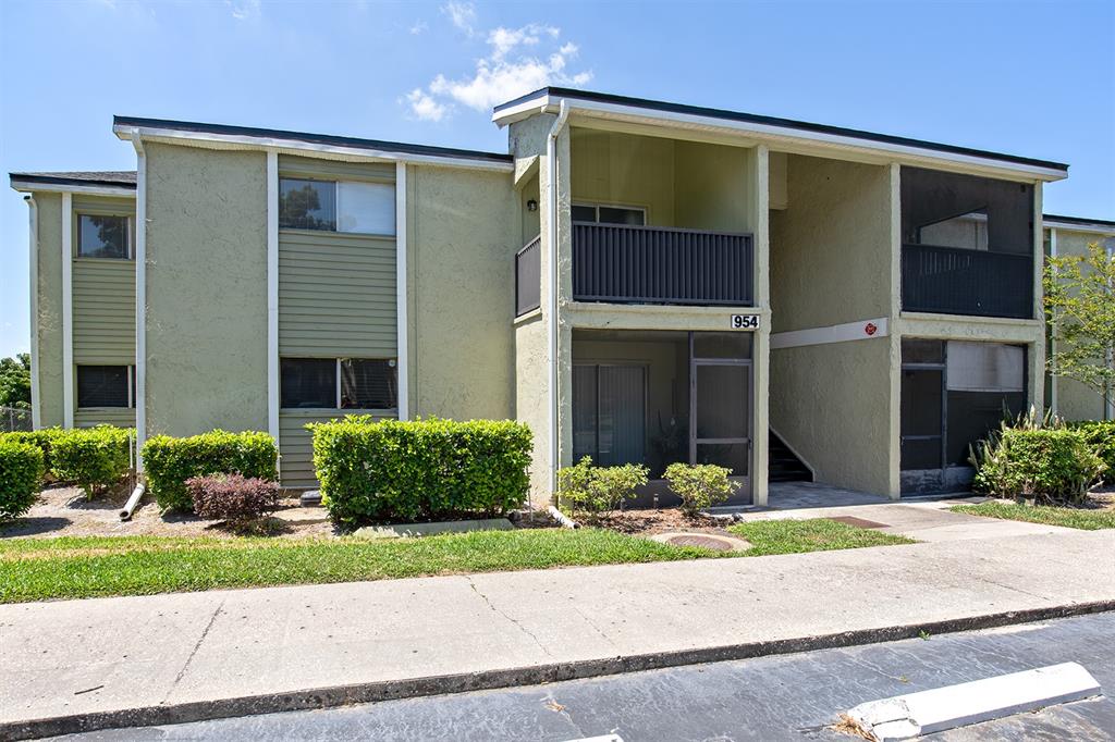 a front view of a house with a yard and potted plants
