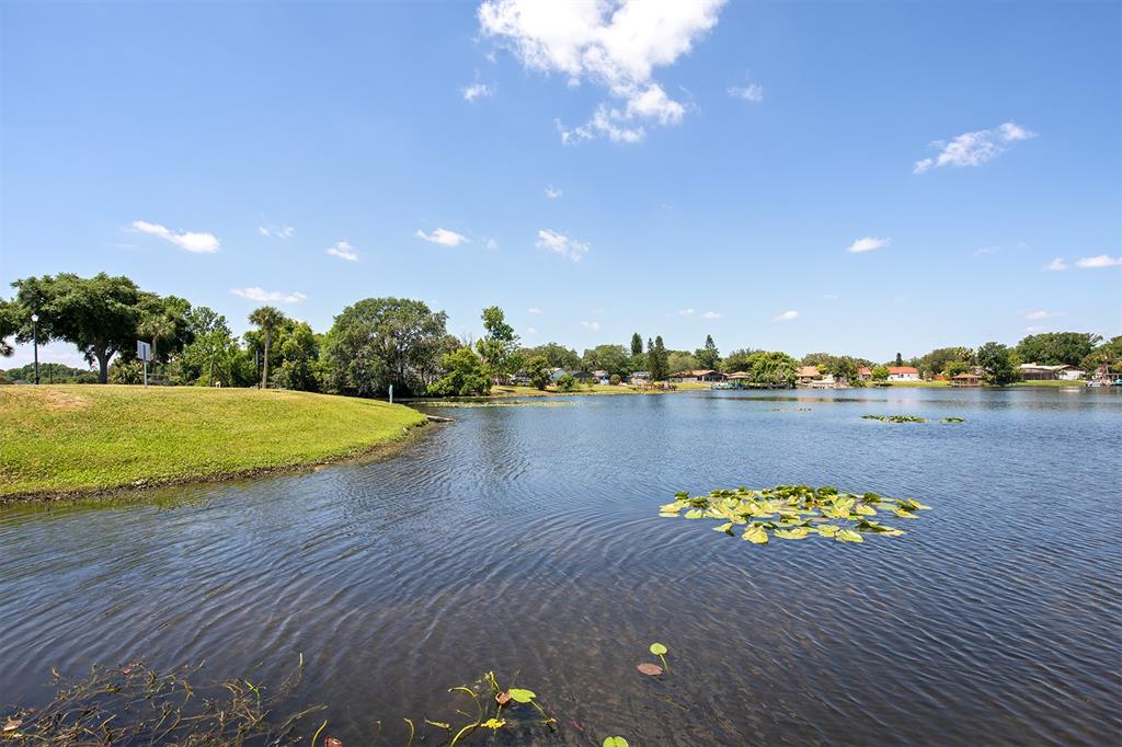 954 Lake Destiny Road, Unit H Altamonte Springs, FL 32714 - Photo 16 of 17 a view of a lake with a table and chairs