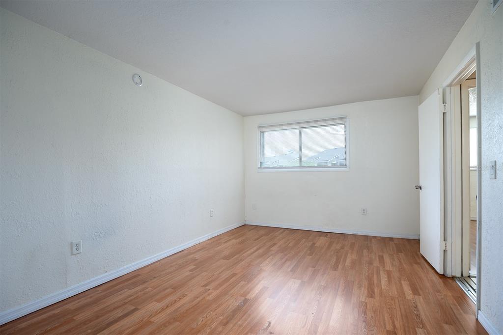 954 Lake Destiny Road, Unit H Altamonte Springs, FL 32714 - Photo 8 of 17 an empty room with wooden floor and windows