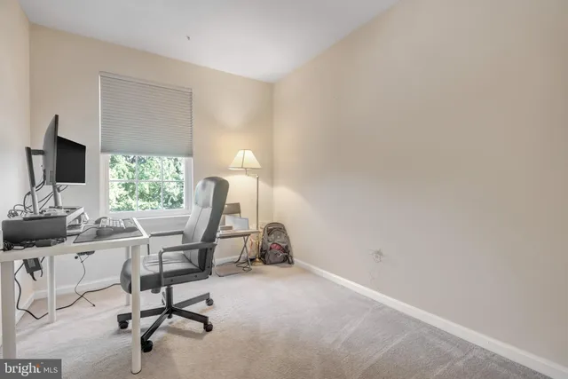 a work room with furniture and a flat screen tv