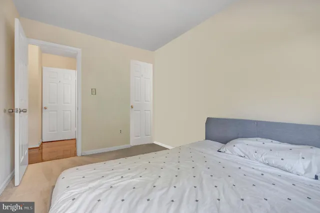 a bedroom with a bed and a mirror