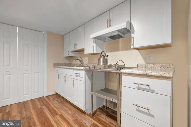 a kitchen with a sink cabinets and appliances