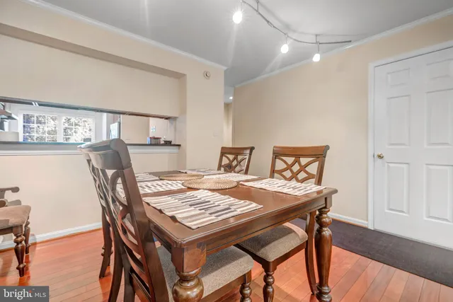 a dining room with furniture and wooden floor