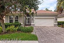 16188 Parque Lane Naples, FL 34110 - Photo 1 of 15 a front view of a house with a yard and garage