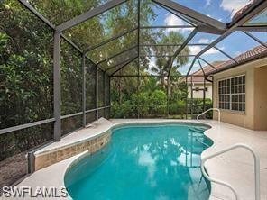 16188 Parque Lane Naples, FL 34110 - Photo 11 of 15 a view of a swimming pool with a yard