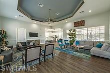 16188 Parque Lane Naples, FL 34110 - Photo 14 of 15 a living room with furniture and a flat screen tv