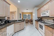 16188 Parque Lane Naples, FL 34110 - Photo 5 of 15 a kitchen with lots of counter top space and stainless steel appliances