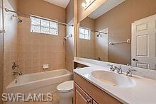 16188 Parque Lane Naples, FL 34110 - Photo 7 of 15 a bathroom with a granite countertop sink toilet and shower