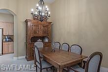 16188 Parque Lane Naples, FL 34110 - Photo 9 of 15 a dining room with furniture and chandelier