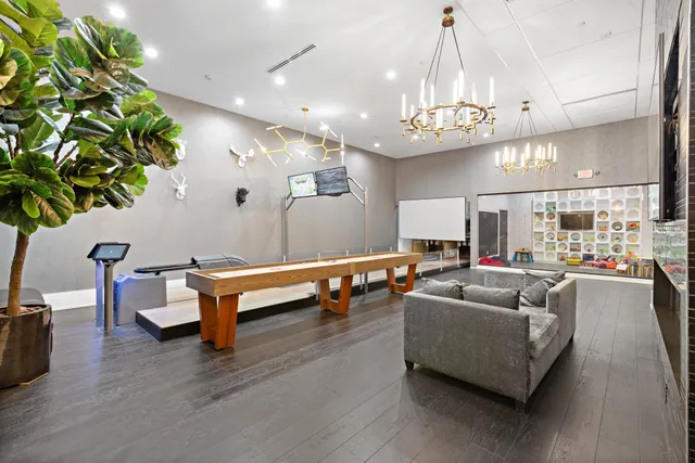 a living room with furniture and a chandelier