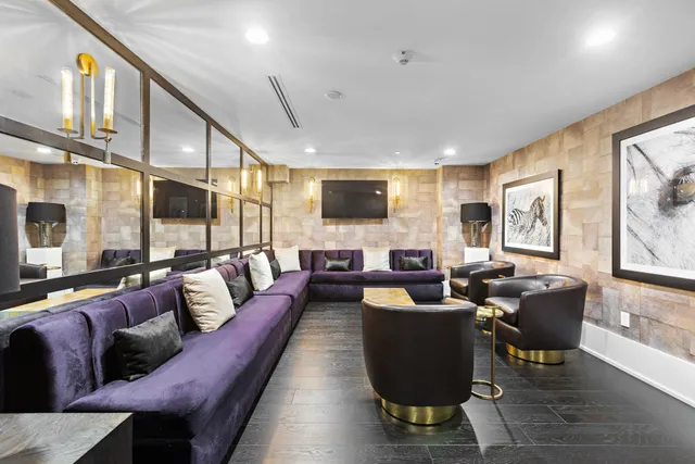 a living room with fireplace furniture and a large window