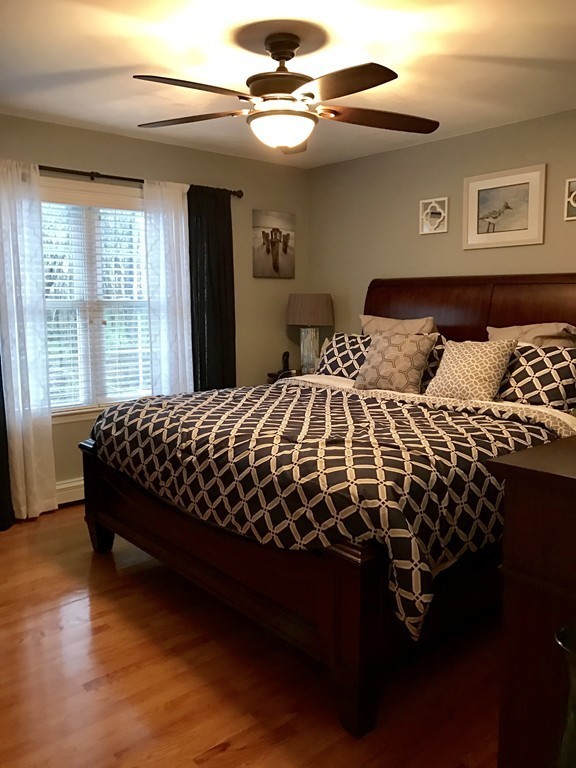 3 Diamond Street Fairhaven, MA 02719 - Photo 11 of 17 a bedroom with a bed and a chandelier