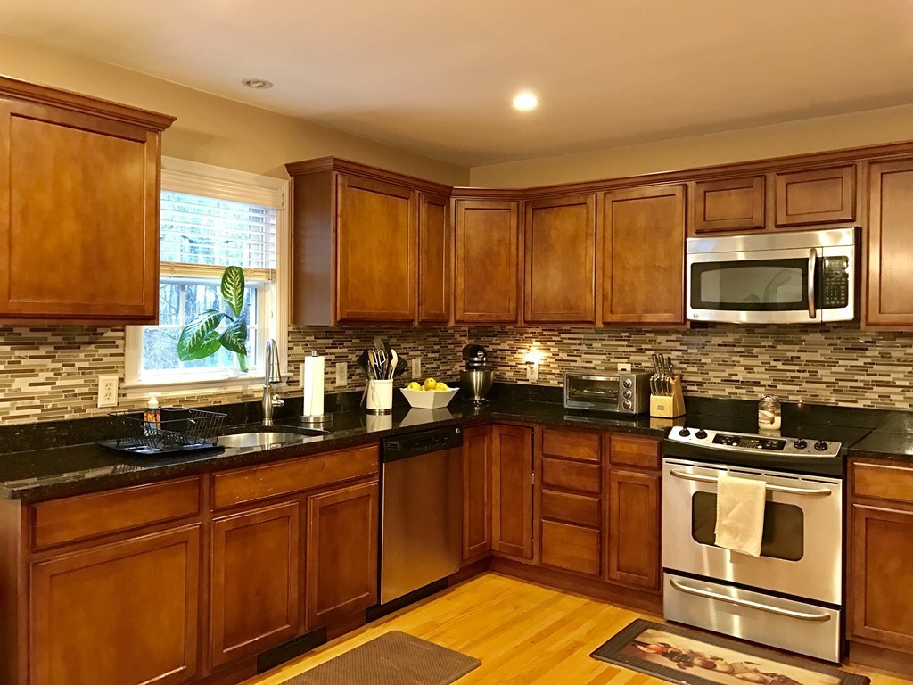 3 Diamond Street Fairhaven, MA 02719 - Photo 7 of 17 a kitchen with granite countertop stainless steel appliances a sink stove and microwave