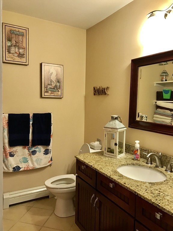 3 Diamond Street Fairhaven, MA 02719 - Photo 9 of 17 a bathroom with a granite countertop toilet sink and mirror