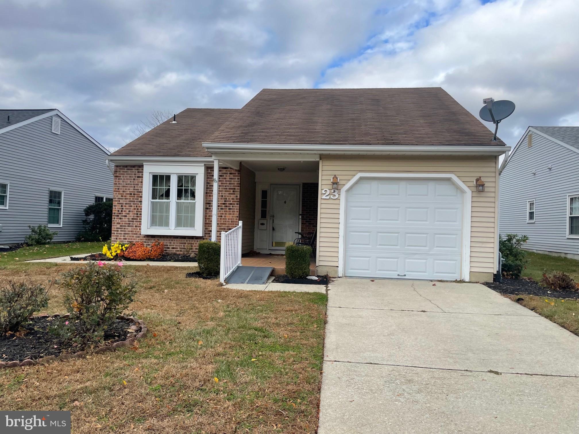 23 Emory Lane Mount Laurel, NJ 08054 - Photo 4 of 4 a front view of a house with a yard and garage