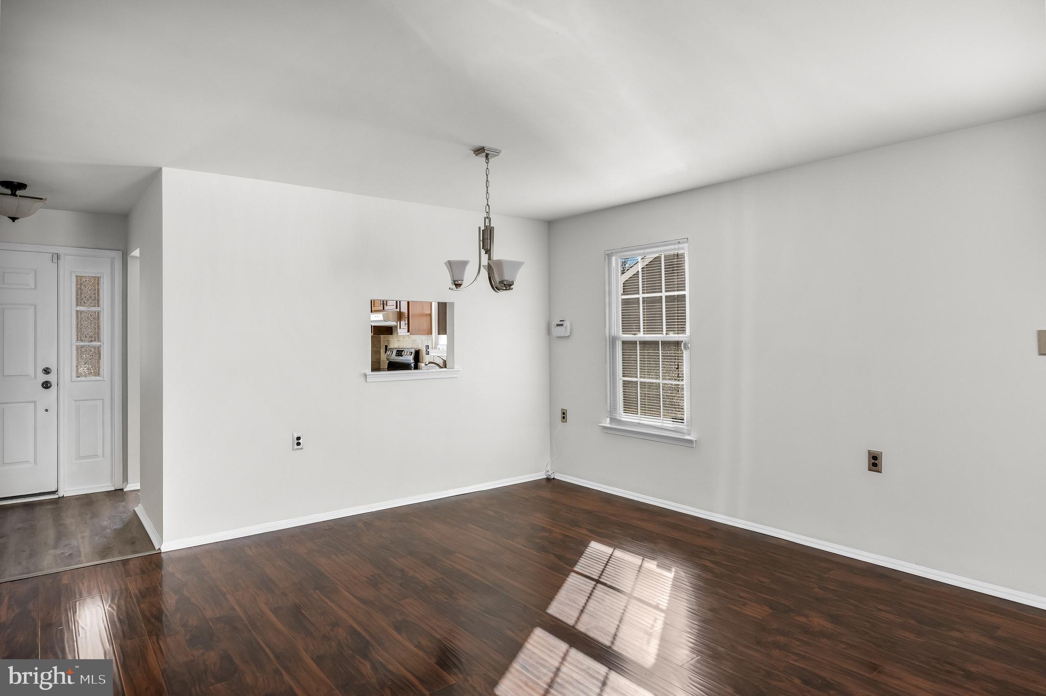 23 Emory Lane Mount Laurel, NJ 08054 - Photo 6 of 23 an empty room with wooden floor cabinet and windows