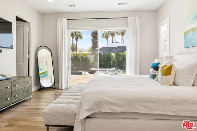 a bedroom with a bed and a large window