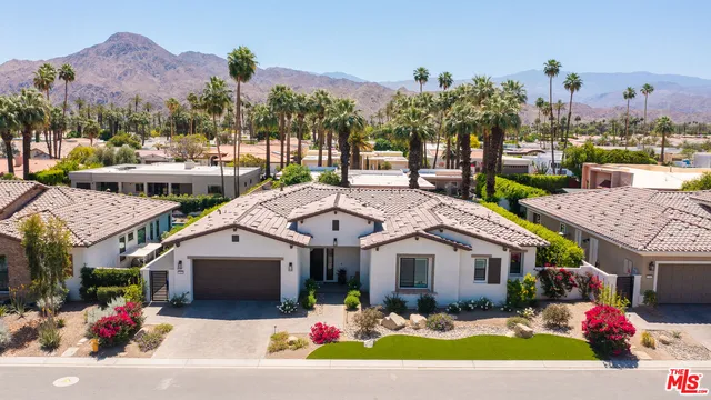 a aerial view of a house with swimming pool and a yard