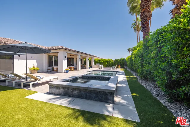 a view of house with swimming pool outdoor seating