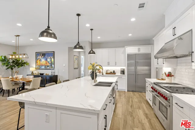 a kitchen with sink stove and refrigerator