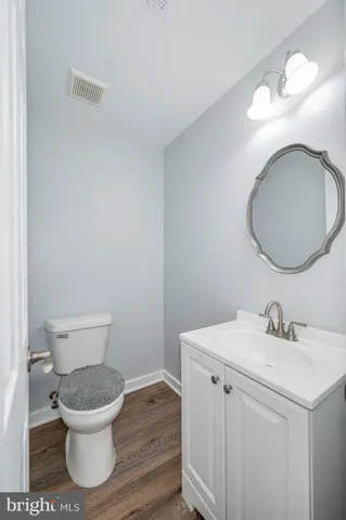 a view of a backyard with potted plants and a wooden bench