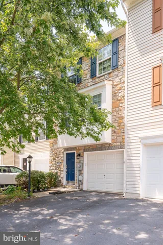 a white house that has a tree in front of it