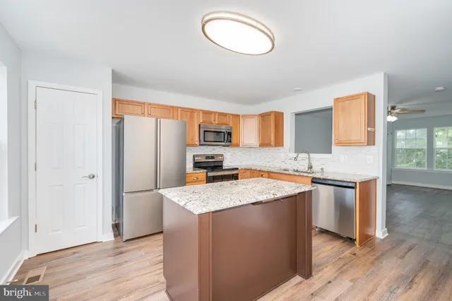 a kitchen with granite countertop stainless steel appliances granite countertop a sink and cabinets