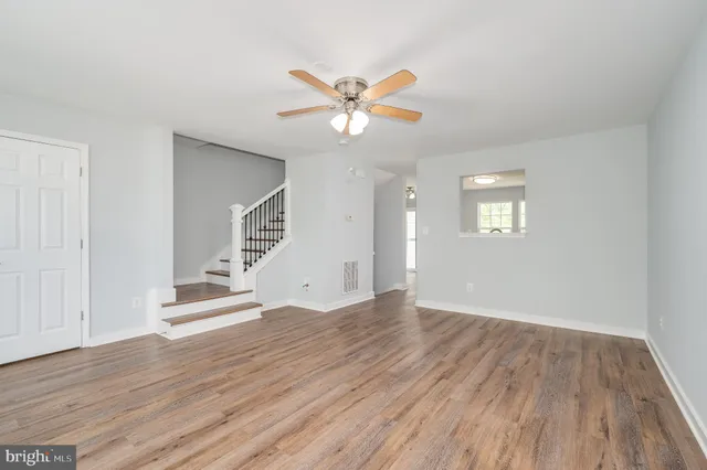 a view of a room with wooden floor and staircase