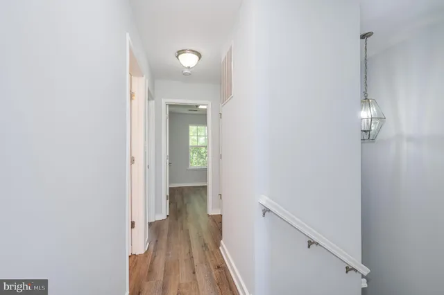 a view of an empty room and wooden floor