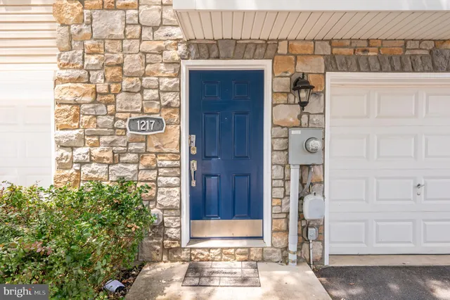 a view of a hallway with wooden floor and entryway