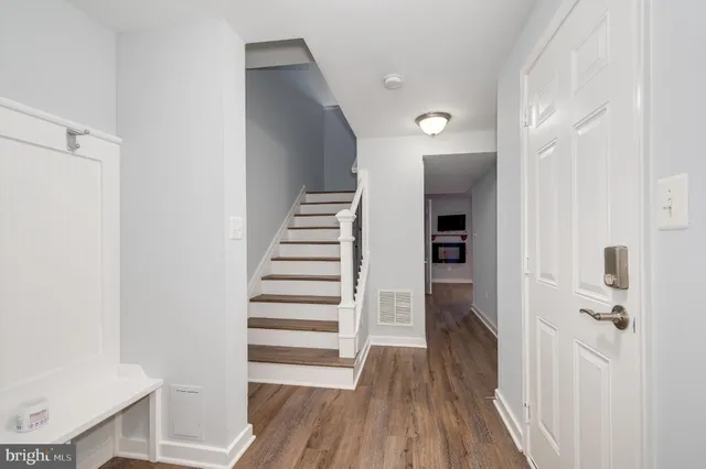 a view of a hallway with wooden floor