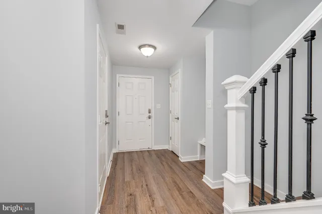 a view of a livingroom with wooden floor and a flat screen tv