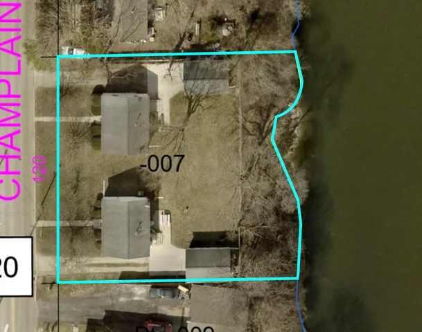 a view of a yard with a house and a large tree