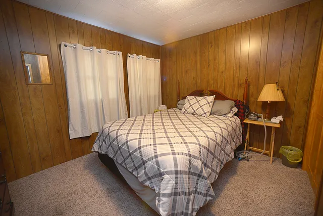 a bedroom with a bed and a table