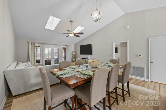 a view of a dining room with furniture wooden floor and chandelier