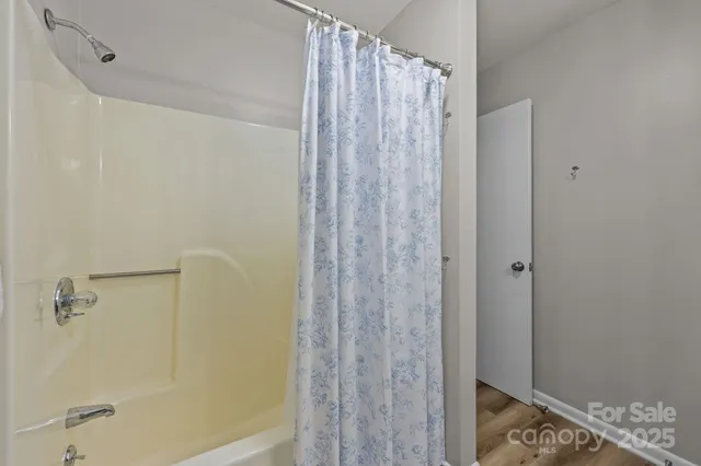 a bathroom with a shower and a curtain