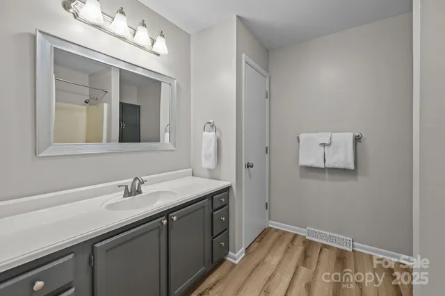 a bathroom with a sink vanity and mirror