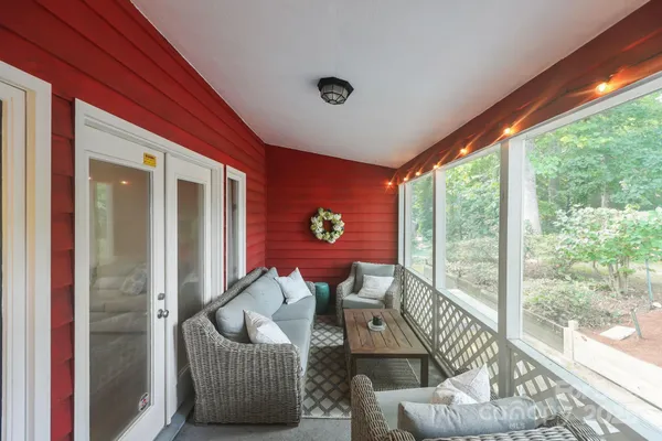 a living room with furniture and a floor to ceiling window