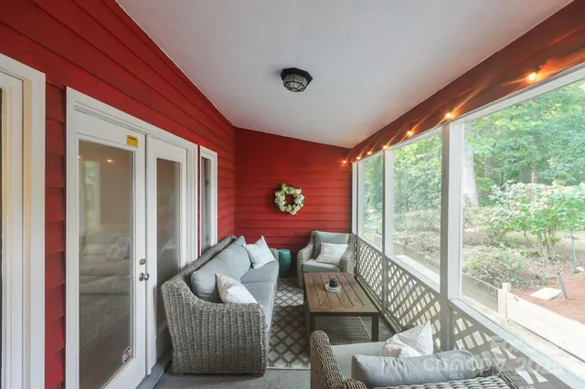 a living room with furniture and a floor to ceiling window
