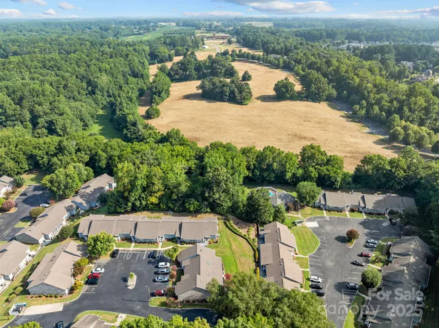 an aerial view of a house with yard swimming pool and lake view