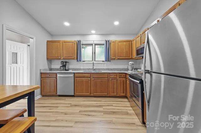 a kitchen with a refrigerator sink and cabinets