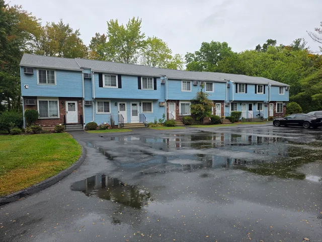 a front view of a house with a yard table and chairs