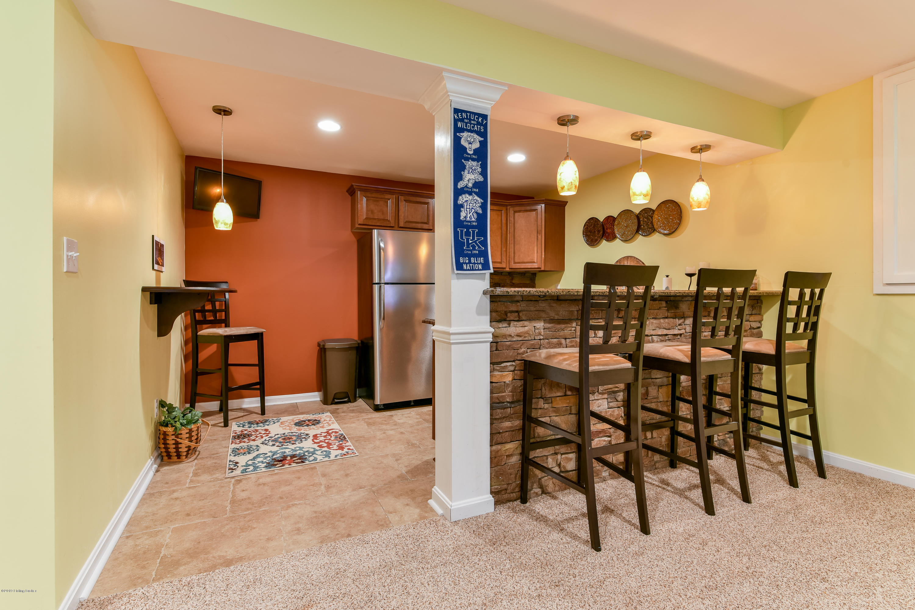 2501 Garrett Pt Road La Grange, KY 40031 - Photo 29 of 69 The wet bar hosts cabinetry, sink, refrigerator and bar top seating with pendant lighting